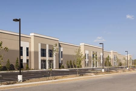 Long low-slope commercial building with landscaped parking lot