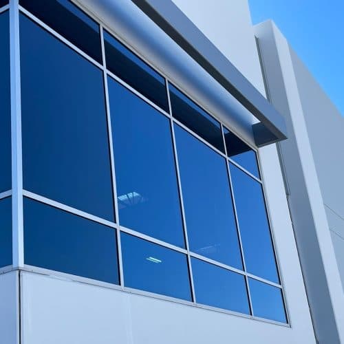 Close-up of a commercial building's glass curtain wall and facade detail