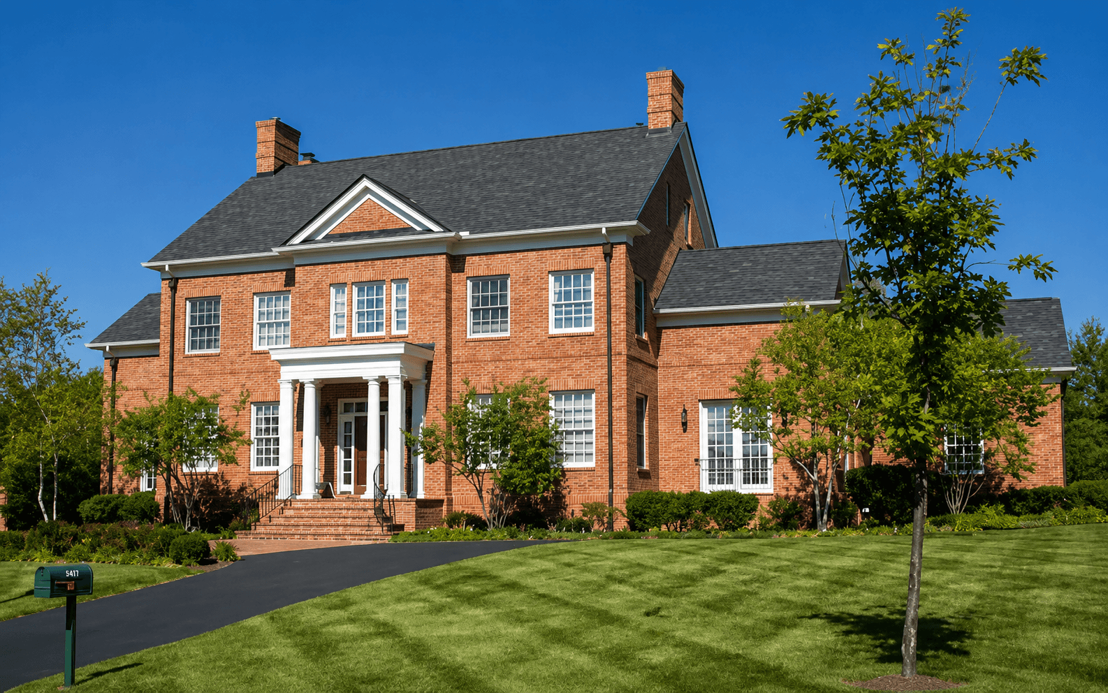 Two-story brick home in Central Texas with a newly installed architectural shingle roof