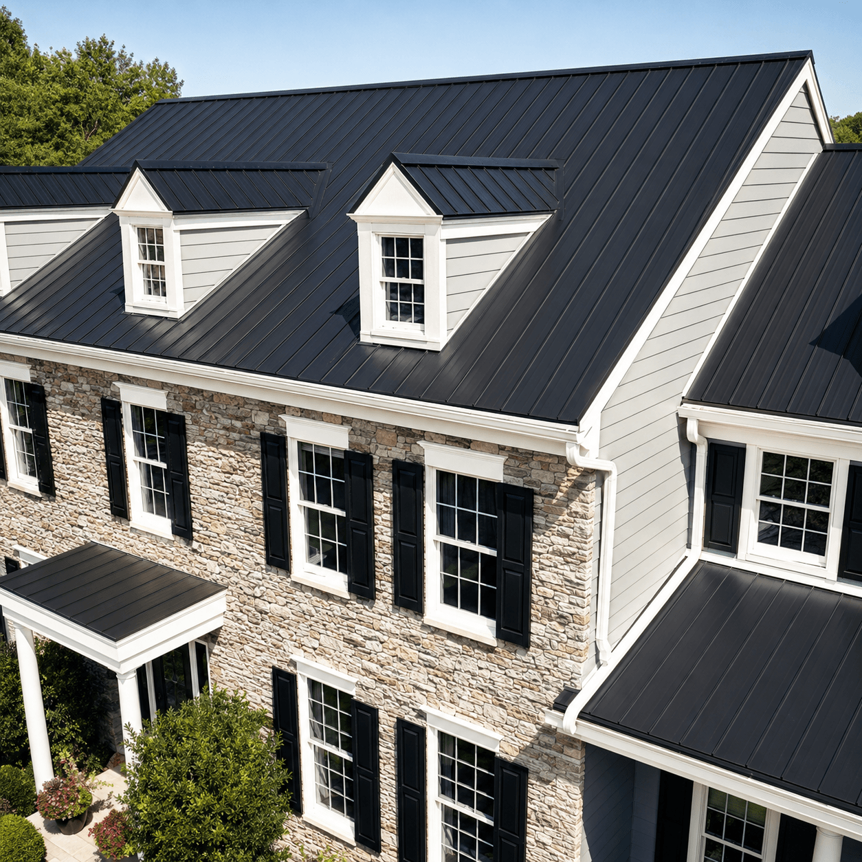 Stone and siding home with a black standing seam metal roof